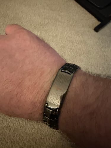 Close-up of a customer's wrist wearing the engraved Power of the Lord’s Prayer Copper Bracelet.