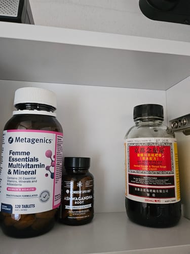 Customer's mini bottle of Ashwagandha Root Capsules on a white shelf next to other supplements.