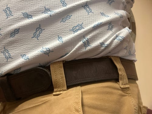 Customer wearing their 1.5-inch wide double bison belt threaded through the loops of their khaki pants.