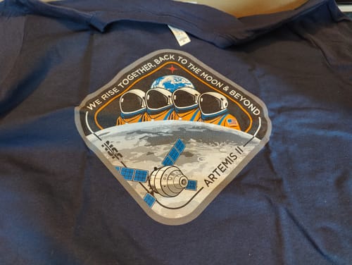 Customer's close-up of the navy blue Artemis II T-shirt, showing the detailed mission patch graphic.