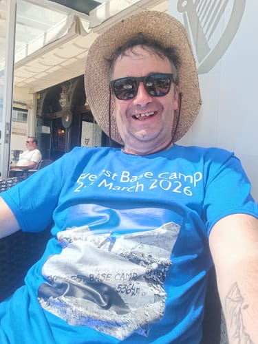 Reviewer smiling outdoors while wearing a blue heavyweight t-shirt with a custom Everest Base Camp print.
