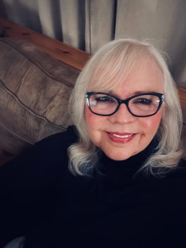 A smiling reviewer shows off her youthful-looking complexion after using F-Balm tallow balm.