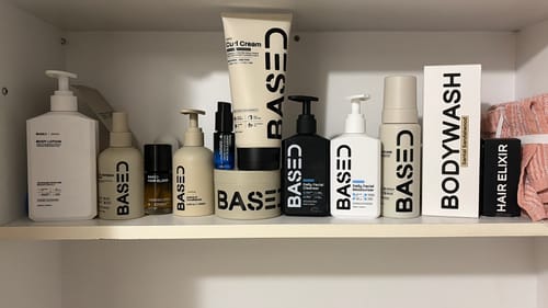 Reviewer's Hydration & Refresh Duo shown among a collection of hair and body products on a shelf.