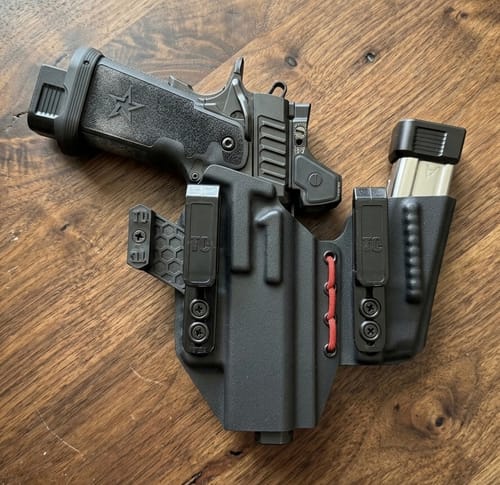 Reviewer's black AXIS ELITE holster with red cord, holding a Staccato P pistol and a spare magazine.