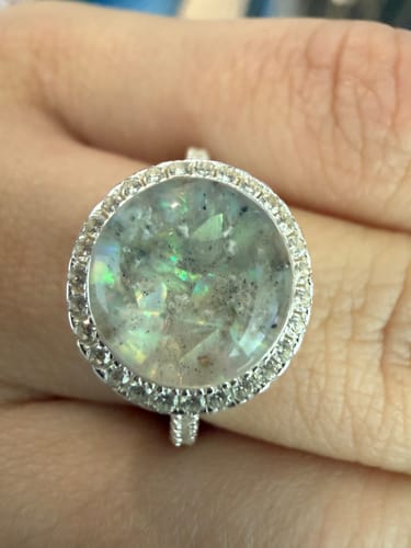Customer's beautiful Bedazzled Circle Opal Cremation Ring with iridescent opal and memorial ashes.
