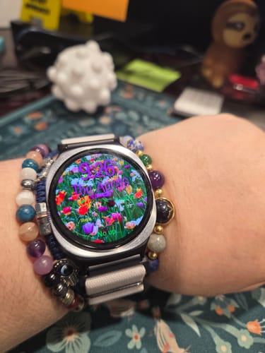 Reviewer's wrist showing the Watchband+ Adapter connecting a light gray fabric band to a silver smartwatch.