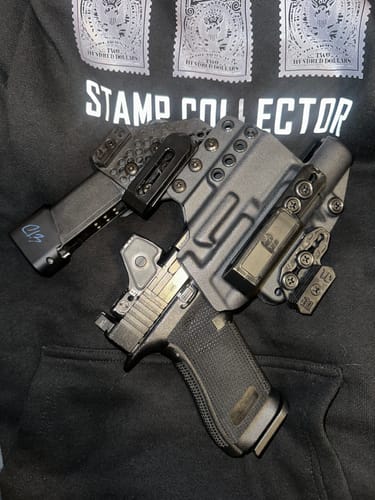 Customer's grey APX holster with an attached magazine carrier and a handgun inside.
