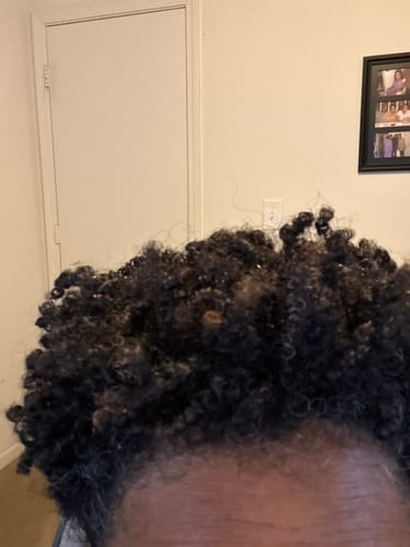 Close-up of a reviewer's defined, coily hair five days after styling with Tropical Oasis Anti-Humidity Hair Gel.