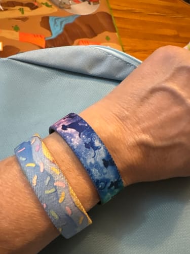 Close-up of a reviewer's wrist showing the Until We Meet Again Dog Bracelet alongside another bracelet.