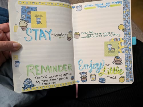 Customer shows a journal page with 'Enjoy the little things' decorated with cute Blueberry Lemonade stickers.
