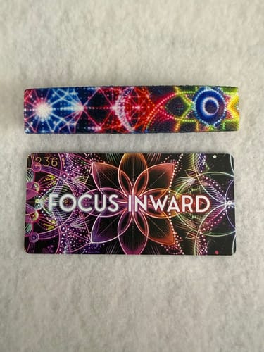 Customer's colorful Focus Inward Bracelet and its matching collector's card laid flat on a surface.