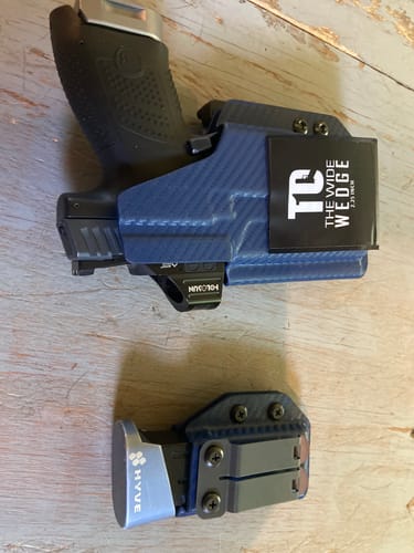 Customer's T1C Wide Wedge attached to a blue holster holding a handgun, with a separate magazine holder nearby.