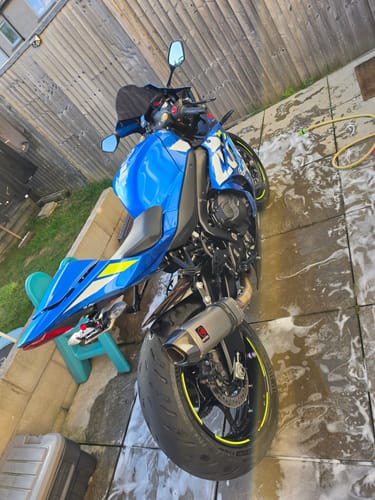 Customer's blue Suzuki GSXR 1000 with a clean tail tidy installed, seen from the rear quarter on a patio.