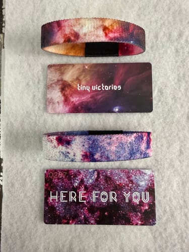 Customer's Space Pack bracelets showing the "Tiny Victories" and "Here For You" designs laid out with their cards.