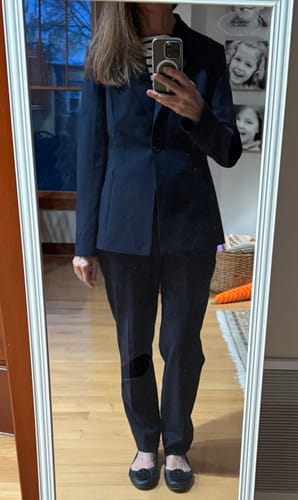 Reviewer showing the fit of the dark navy Colby Travel Pant as part of a business suit.