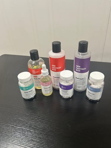 Reviewer's Body Magic Chlorophyll Pill bottle, with a teal label, among other products from the collection on a table.