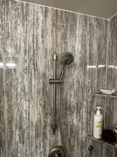 Customer's stainless steel 3-Spray Handheld Shower Head installed on a vertical slide bar in a shower.