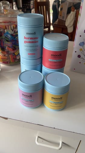 Customer's collection of moodi products, including the Pre + Probiotic Bundle, displayed on a white table.