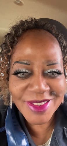 Close-up of a reviewer wearing pale gray Halloween Blueout contact lenses.