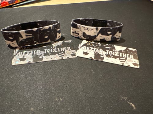 Customer's two 'Better Together' wristbands with one standard card and one shiny first edition card.