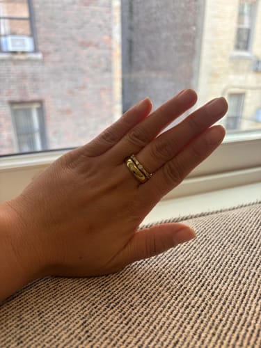 Customer's hand showing the gold Classic Stacking Ring worn stacked with a second ring.