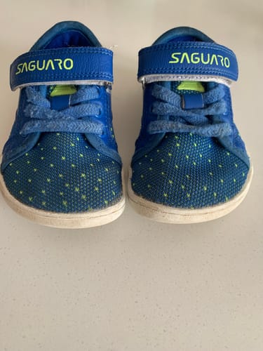 Customer's pair of worn, blue Kid's Luck Ⅰ Barefoot Shoes, shown from the front after four months of use.