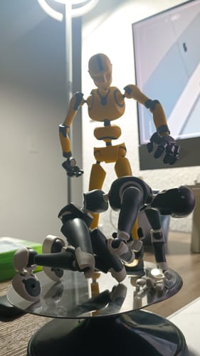 Customer's Dark Frost Stickybones figure posed on all fours on a magnetic plate, with another figure standing over it.