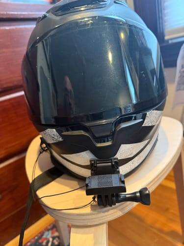 Customer's black Shoei Camera Mount securely attached to the chin of a motorcycle helmet, ready for use.