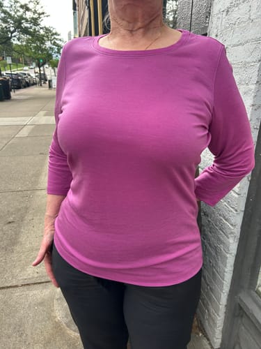 Reviewer shows the fit of the size M Jenny 3/4 Sleeve Crew Neck top in purple wine.