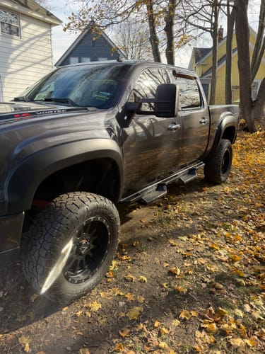 Reviewer's lifted grey Silverado truck showcasing the improved stance after installing the Front Upper Control Arms.