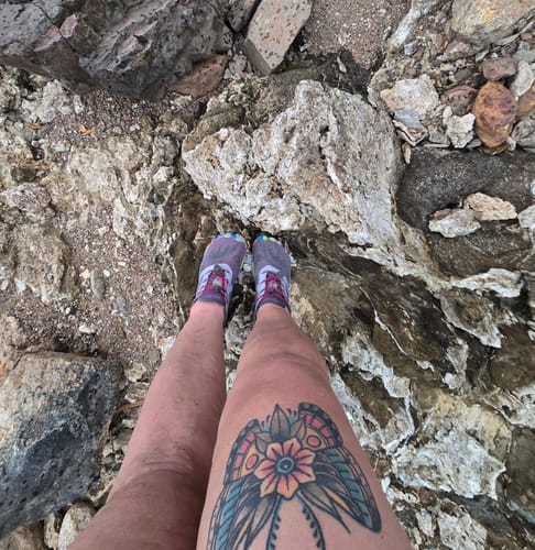 A customer's first-person view of their Smart II - Barefoot Shoes while standing on a rocky surface.