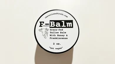 Customer's top-down view of the round F-Balm tin, highlighting its black and white label.