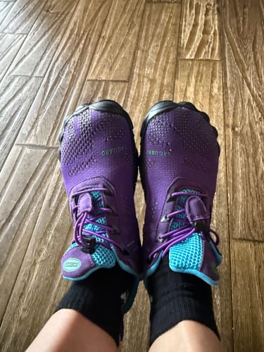 A reviewer's feet wearing the vibrant purple and turquoise Free Ⅰ - Barefoot Shoes.