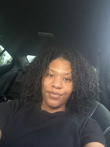 Reviewer showing their defined, curly braid-out style after using Tropical Oasis Hair Gel.
