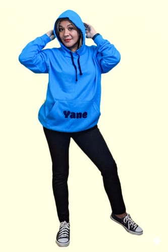 Reviewer wearing a personalized blue Varsity hoodie with the hood up.