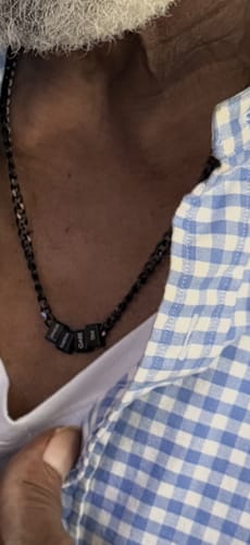 Close-up of a customer wearing the black stainless steel Legacy necklace with small beads.