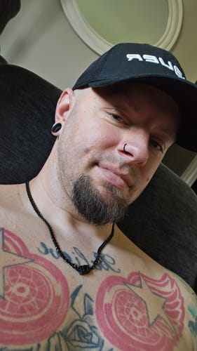 Close-up of a customer wearing the black stainless steel Legacy necklace against his chest.
