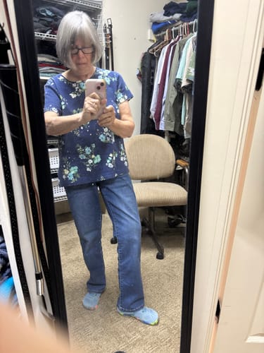 Reviewer in a mirror selfie wearing the blue Kid's Smart Ⅰ - Barefoot Shoes with jeans in a closet.