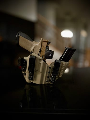 Customer's tan AXIS ELITE holster holding a pistol with a red dot sight and a spare magazine.