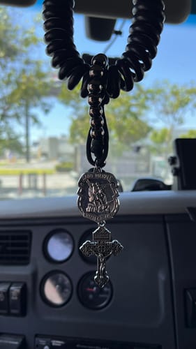 Customer's black and silver Dual Use Car Pendant & Pocket Rosary hanging inside their truck cab.