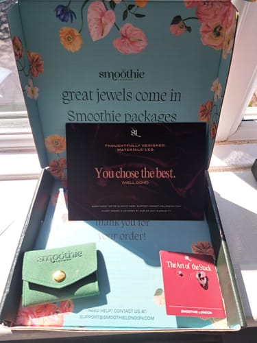 Customer showing the box containing the Everyday Ear Party earring set, with its pouch and cards.