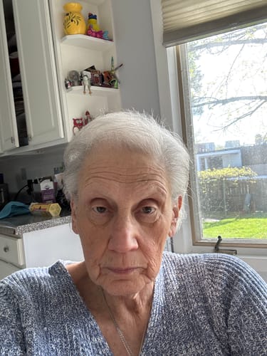 A selfie-style portrait of the reviewer in their kitchen.