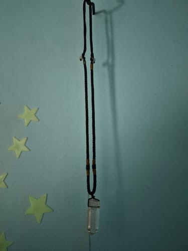 Reviewer's Clear Cortez necklace hanging on a wall.