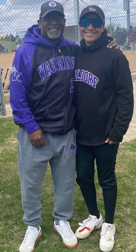 Customer wearing a custom black and purple stitched Full-Zip Sweatshirt Hoodie standing with another person.