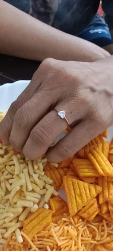 Customer's hand wearing the Rose Gold Flirty Heart Ring, showing the heart-shaped zircon.