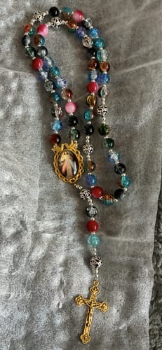 Reviewer's beautiful multicolor glass bead rosary with a brass crucifix and Divine Mercy medal.