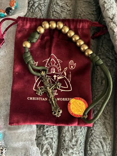 Customer's St. Benedict Pocket Rosary with bronze beads and green cord, displayed on its burgundy pouch.