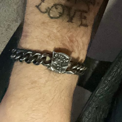 Close-up: Customer wearing the St. Michael's 'Protect Us' Cuban Link Bracelet on their wrist.