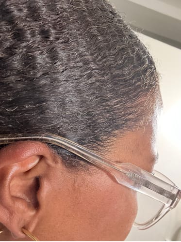 Close-up of a customer's defined, wavy hair styled with Tropical Oasis Firm Hold Hair Gel.