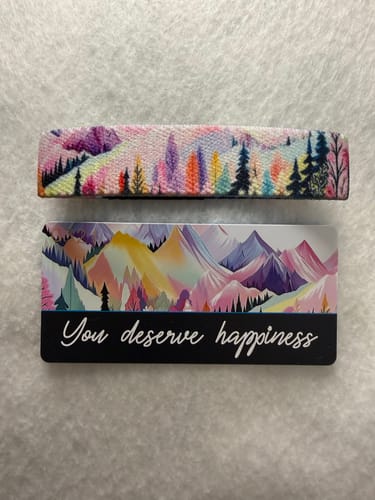 Reviewer's You Deserve Happiness Bracelet and its matching card, both showing a colorful, artistic mountain landscape.